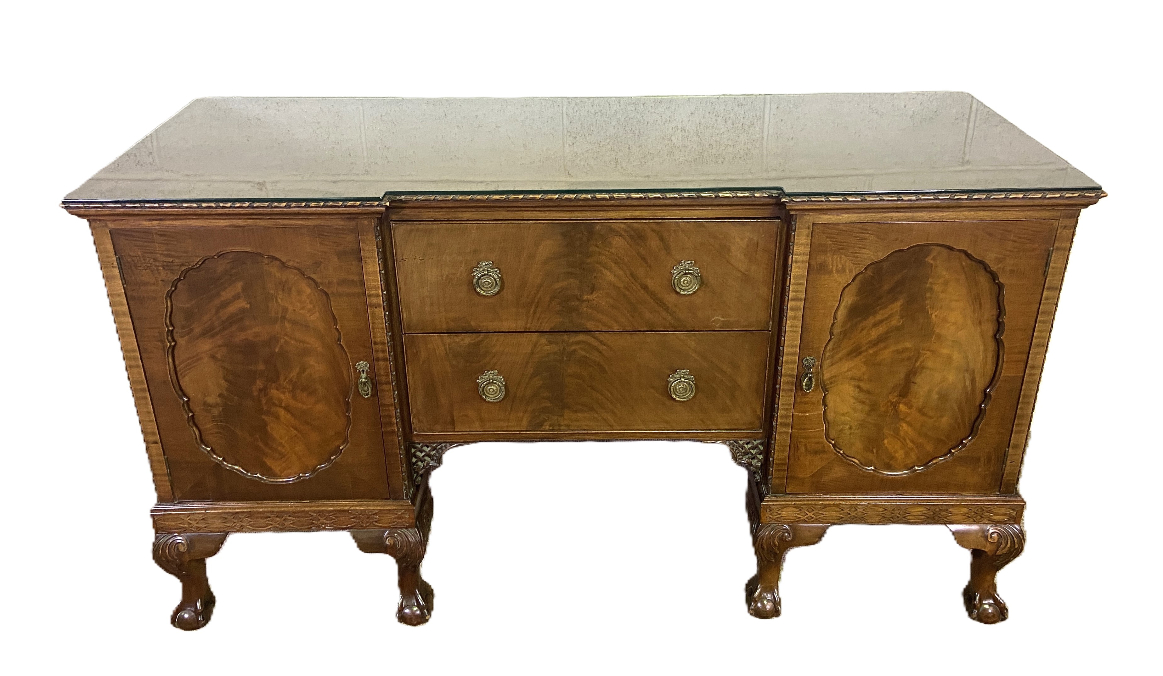 A George III style breakfront mahogany veneered sideboard, the plain top with a moulded edge, over