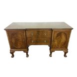 A George III style breakfront mahogany veneered sideboard, the plain top with a moulded edge, over