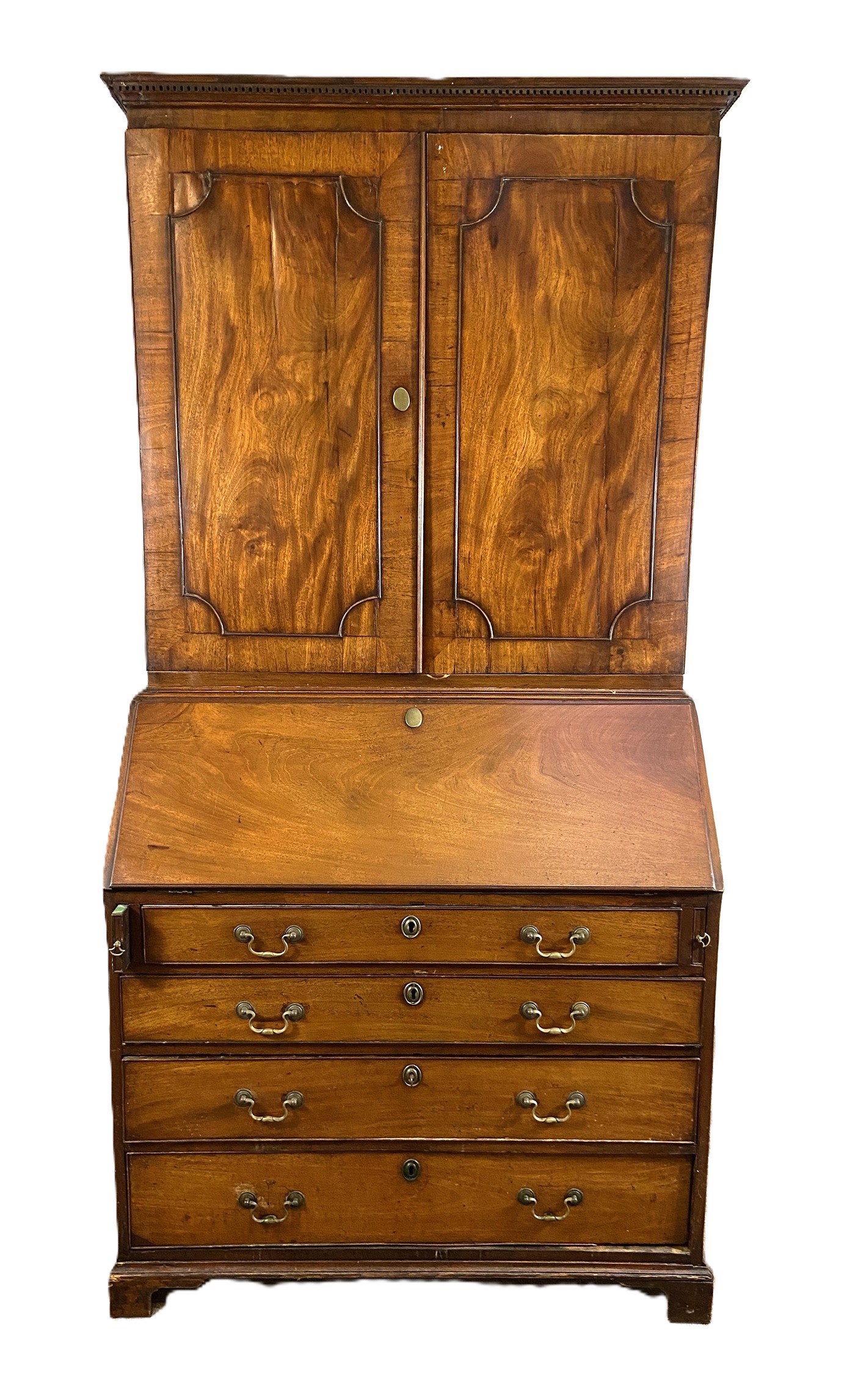 A George III mahogany bureau bookcase, the moulded cornice over two panelled doors, opening to