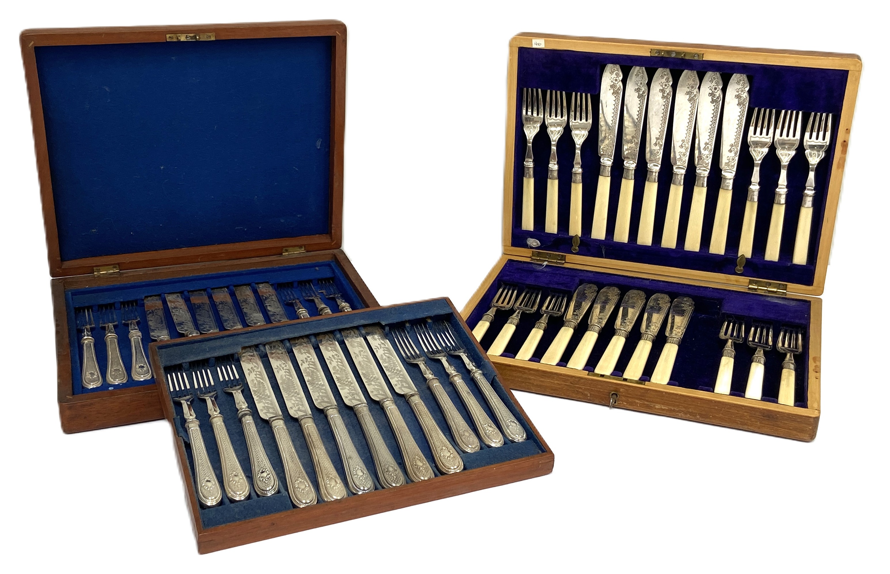 Two cased sets of flatware, including a set of twelve pairs of fruit eaters, and a set of fish