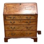A George III mahogany bureau, late 18th century, with a fall front, opening to arrangement of