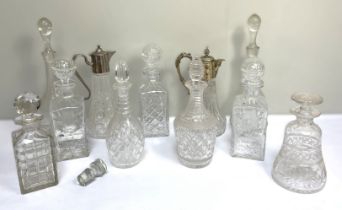 A group of vintage glass decanters, including two silver plate mounted claret jugs; a mallet