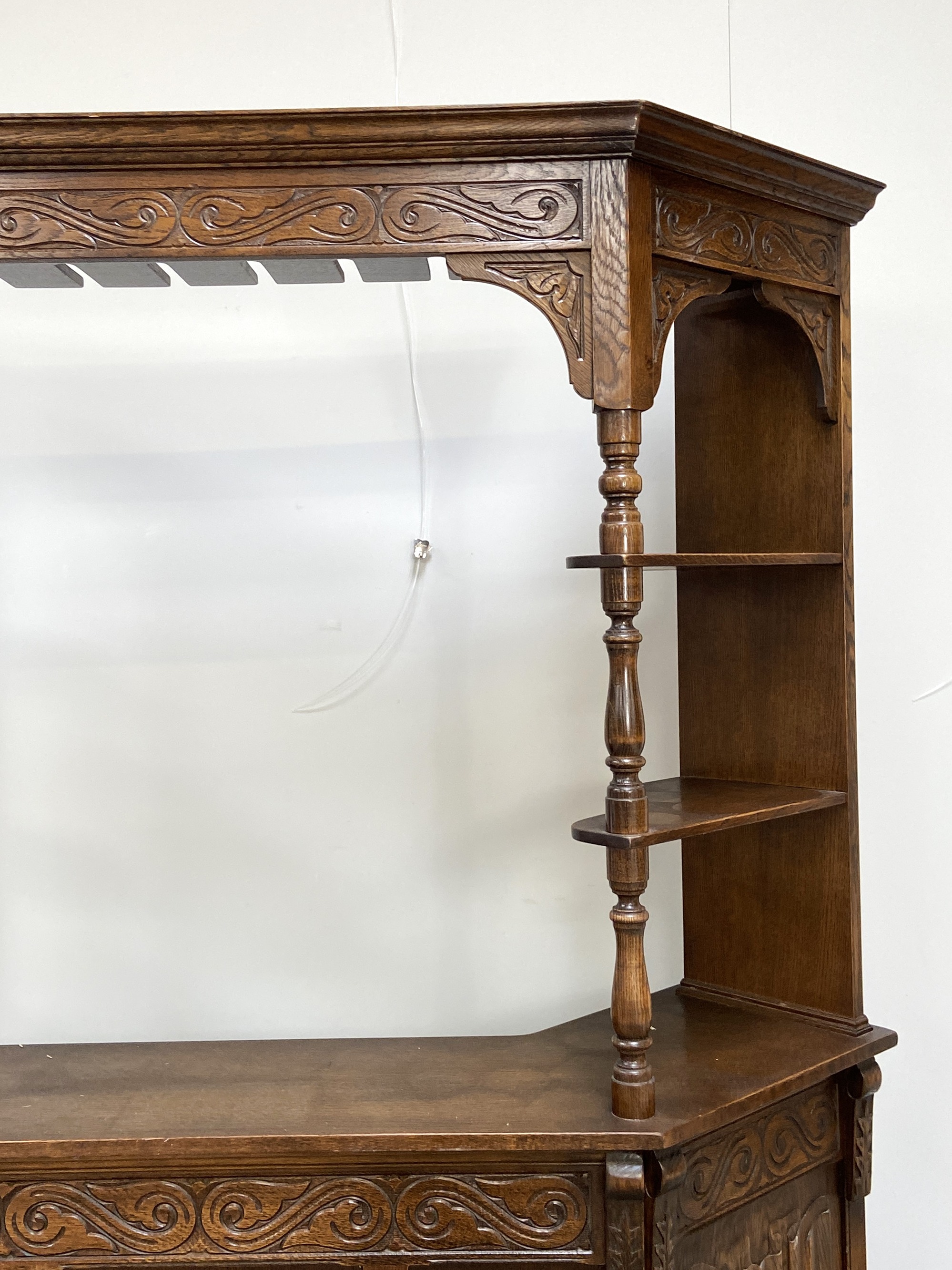 A vintage oak Jacobean style bar, mid 20th century, with canted sides and arched cornice over the - Image 3 of 5