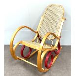 A modern bentwood rocking chair, with caned seat