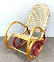 A modern bentwood rocking chair, with caned seat