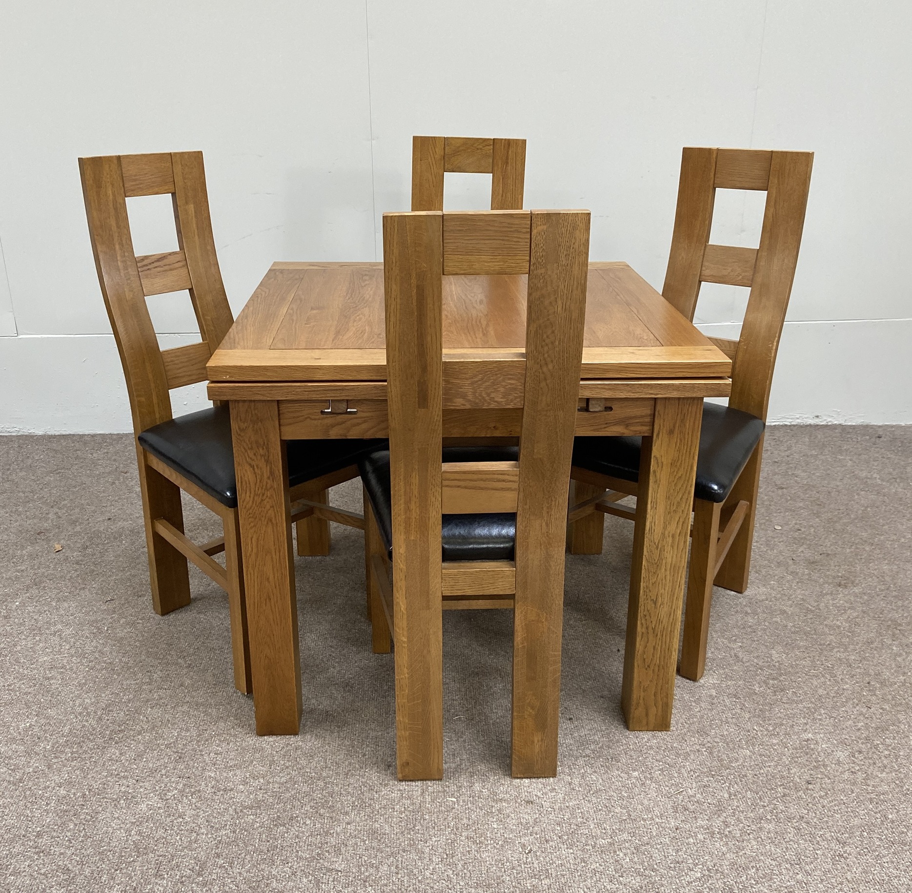 A large and modern oak dining suite, labelled JB Global, including a draw leaf dining table, four