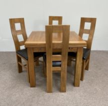 A large and modern oak dining suite, labelled JB Global, including a draw leaf dining table, four