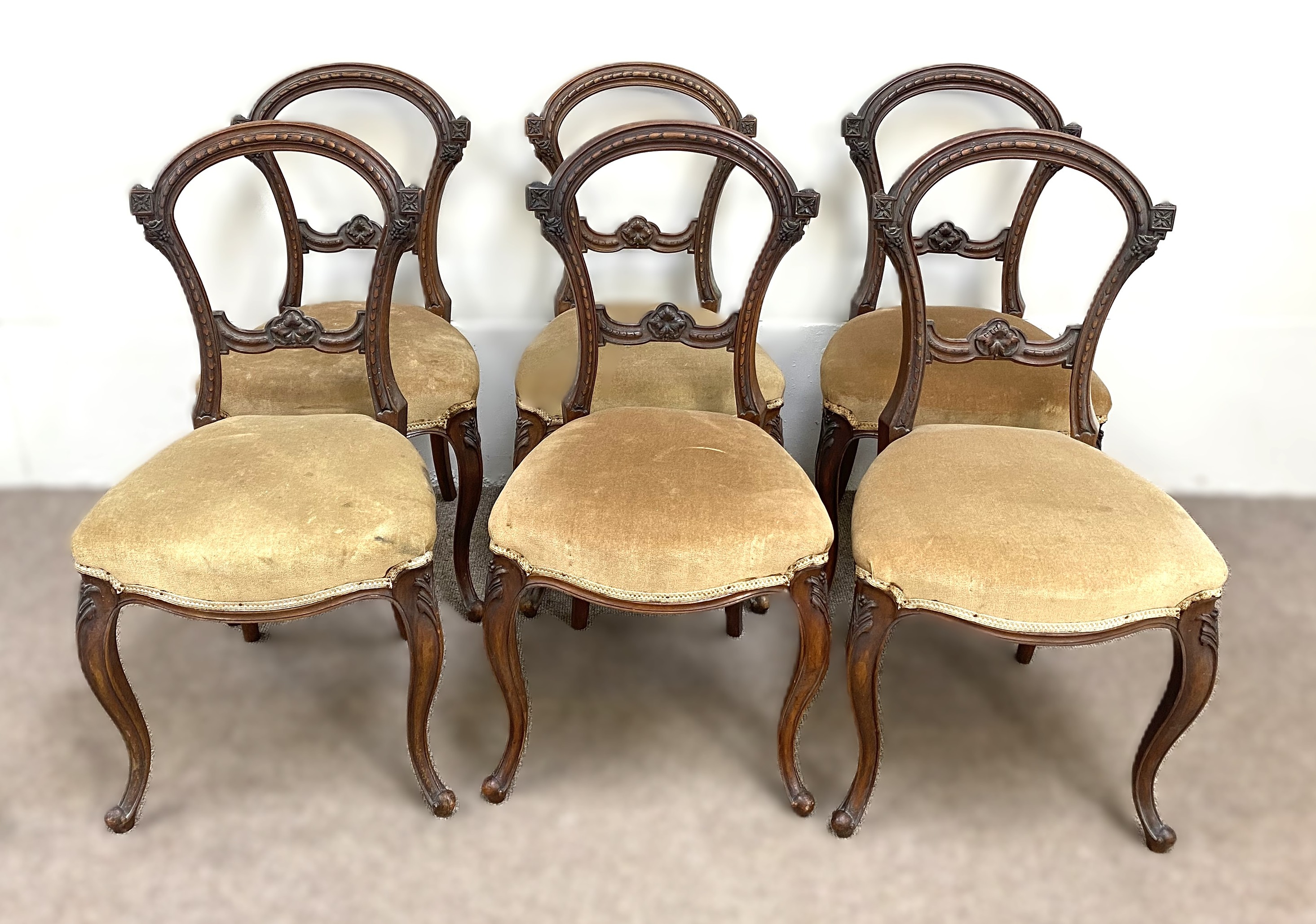 A set of six mid Victorian hoop backed dining chairs, with moulded frames and beige fabric stuffed-