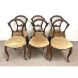 A set of six mid Victorian hoop backed dining chairs, with moulded frames and beige fabric stuffed-