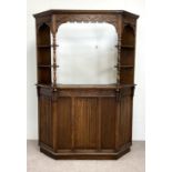 A vintage oak Jacobean style bar, mid 20th century, with canted sides and arched cornice over the