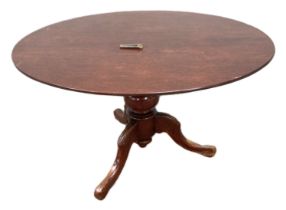 A Victorian style mahogany breakfast table, with circular top on a pedestal base and three curved