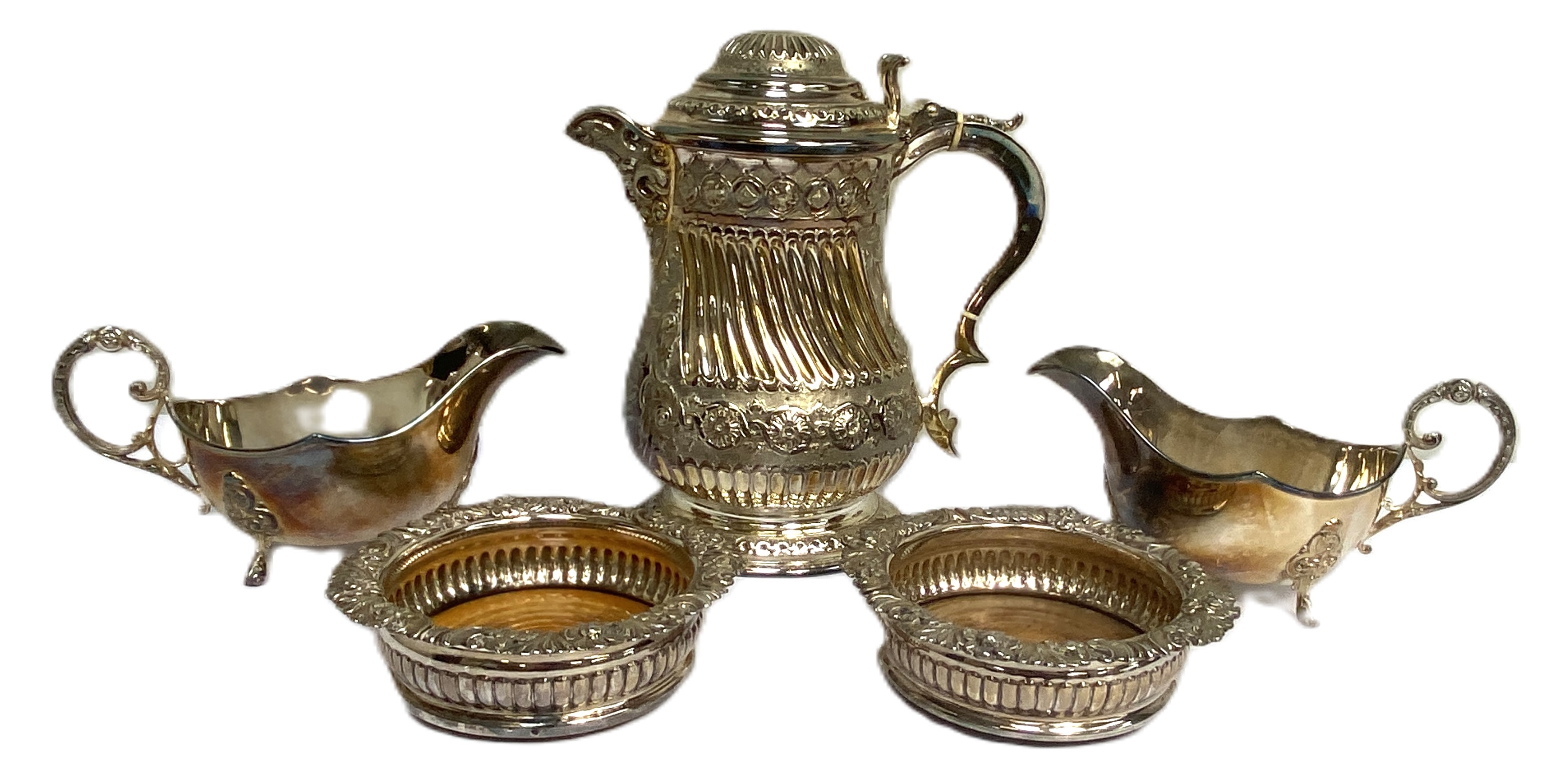 An impressive silver plated Queen Anne Style baluster covered jug, with embossed decoration and