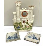 Two Dutch Delft tin glazed blue and white decorated tiles (apparently found in an Amsterdam cellar);