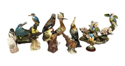 A collection or ceramic figures of birds, including a Goebel porcelain figure of a Jay; also two