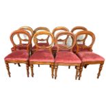 A set of Victorian style balloon backed dining chairs, each with a stuffed seat squab, currently