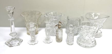 A collection of various cut glass jugs, a small pair of candlesticks, a flared vase and similar