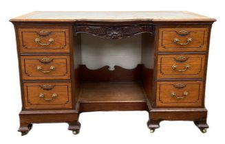A late Victorian mahogany kneehole desk, with shaped and moulded oblong top over a footwell and