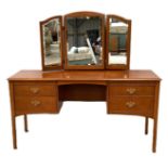 A modern 'mahogany' dressing table, with fitted triple folding mirror over a niche and four drawers;