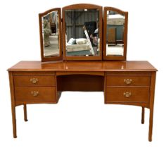 A modern 'mahogany' dressing table, with fitted triple folding mirror over a niche and four drawers;