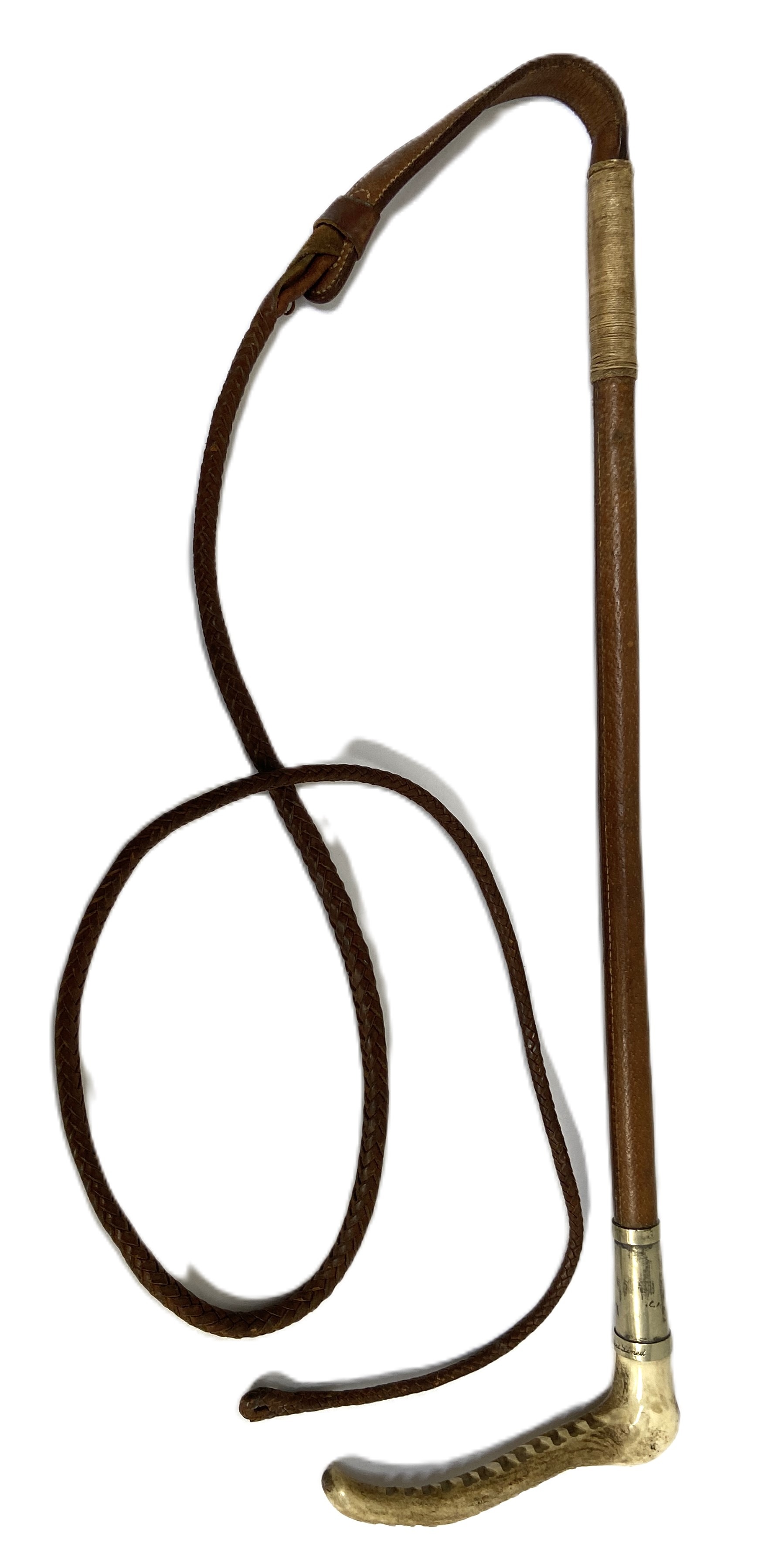 A vintage riding whip, circa 1930, with horn handle and leather shaft and woven whip