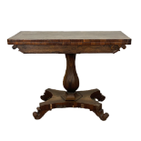 A George IV rosewood tea table, circa 1820, with a rounded rectangular fold-over top, rotating to