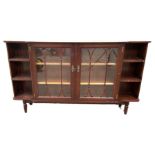 A Georgian style low bookcase, modern, with two glazed bookcase doors flanked by open shelves,