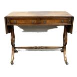 A Regency style mahogany veneer sofa table, with drop leaf top and Lyre end supports, 74cm high,