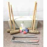 A vintage croquet set, with four hand made mallets, wire hoops and six plastic coloured balls, in