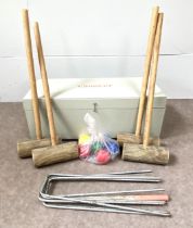 A vintage croquet set, with four hand made mallets, wire hoops and six plastic coloured balls, in