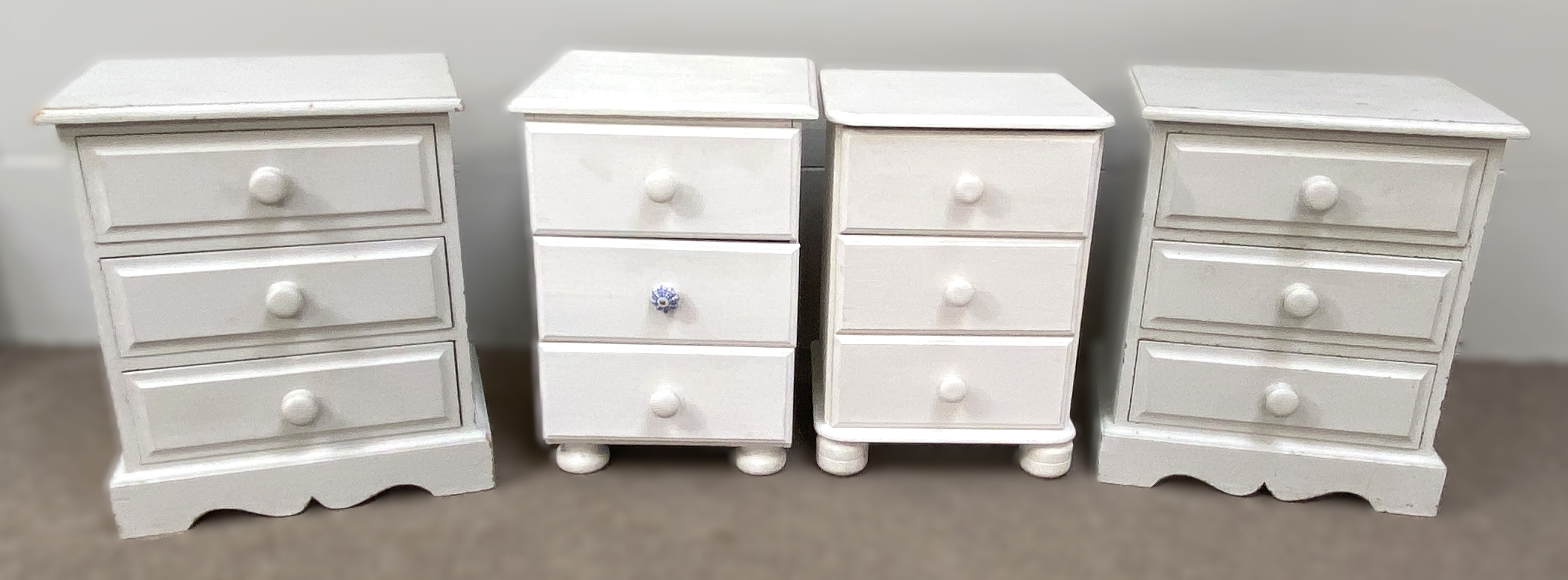 A pair of grey painted bedside chests, each with three drawers, 50cm wide; and two other white