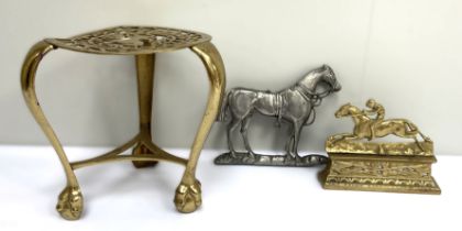 A 19th century brass horse mounting stool, with three legs and cented by a fretwork cut horse;