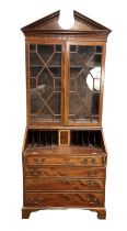 A George III style mahogany bureau bookcase, circa 1900, with a broken pediment over two astragal