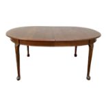 A small vintage Victorian style mahogany dining table, with oval top on four legs with pad feet