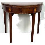 A George III mahogany demi lune tea table, late 18th century, with foldover top and inlaid frieze on