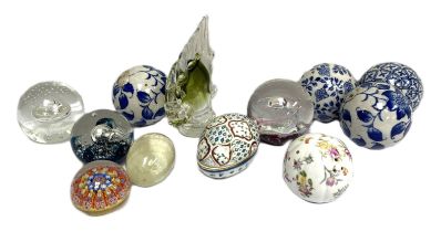 Four assorted glass decorative paperweights, together with a polished agate egg and a group of