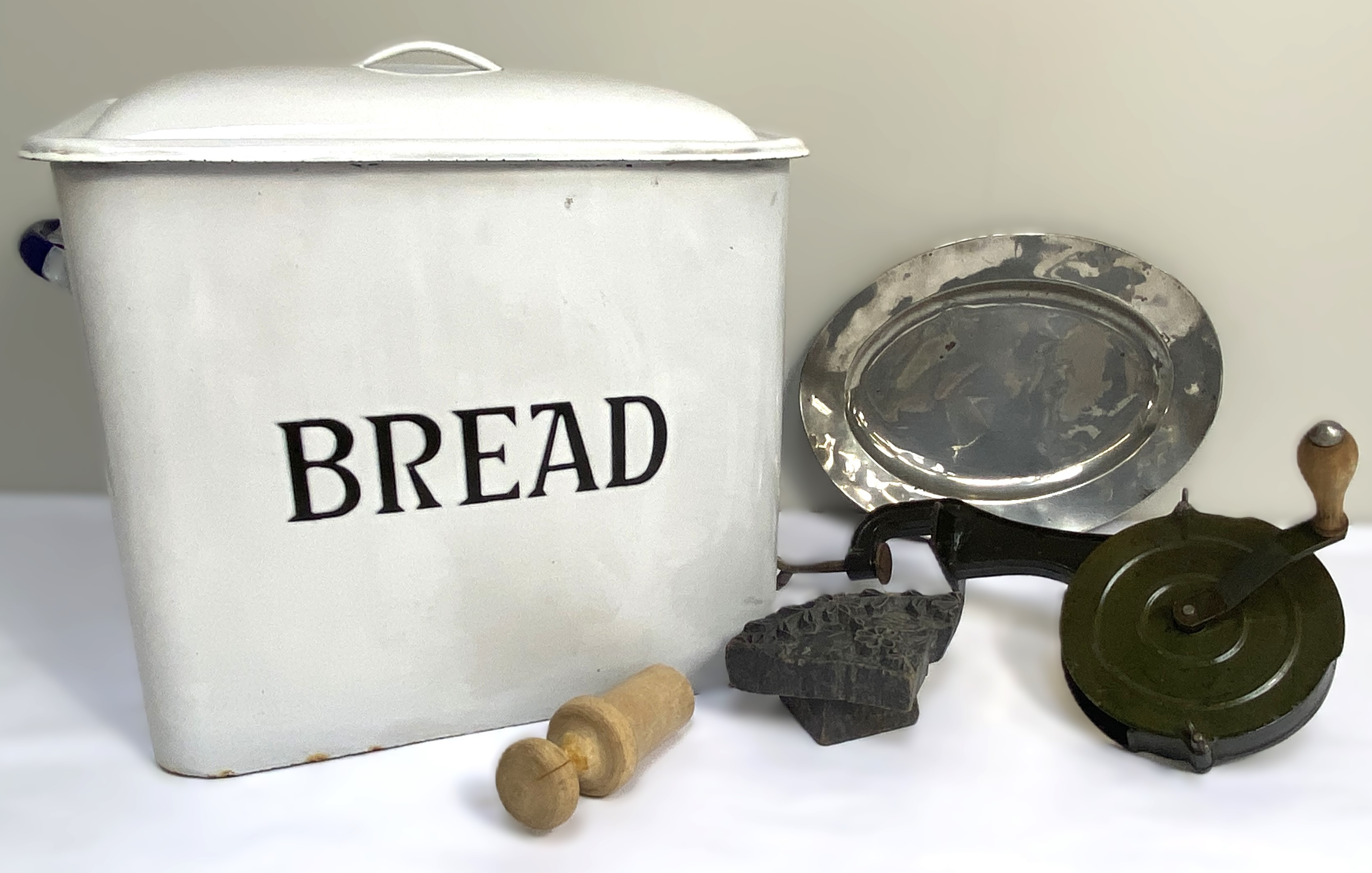 A large vintage enamelled tin Bread bin; together with a table mounted ‘marmalade cutter’ and