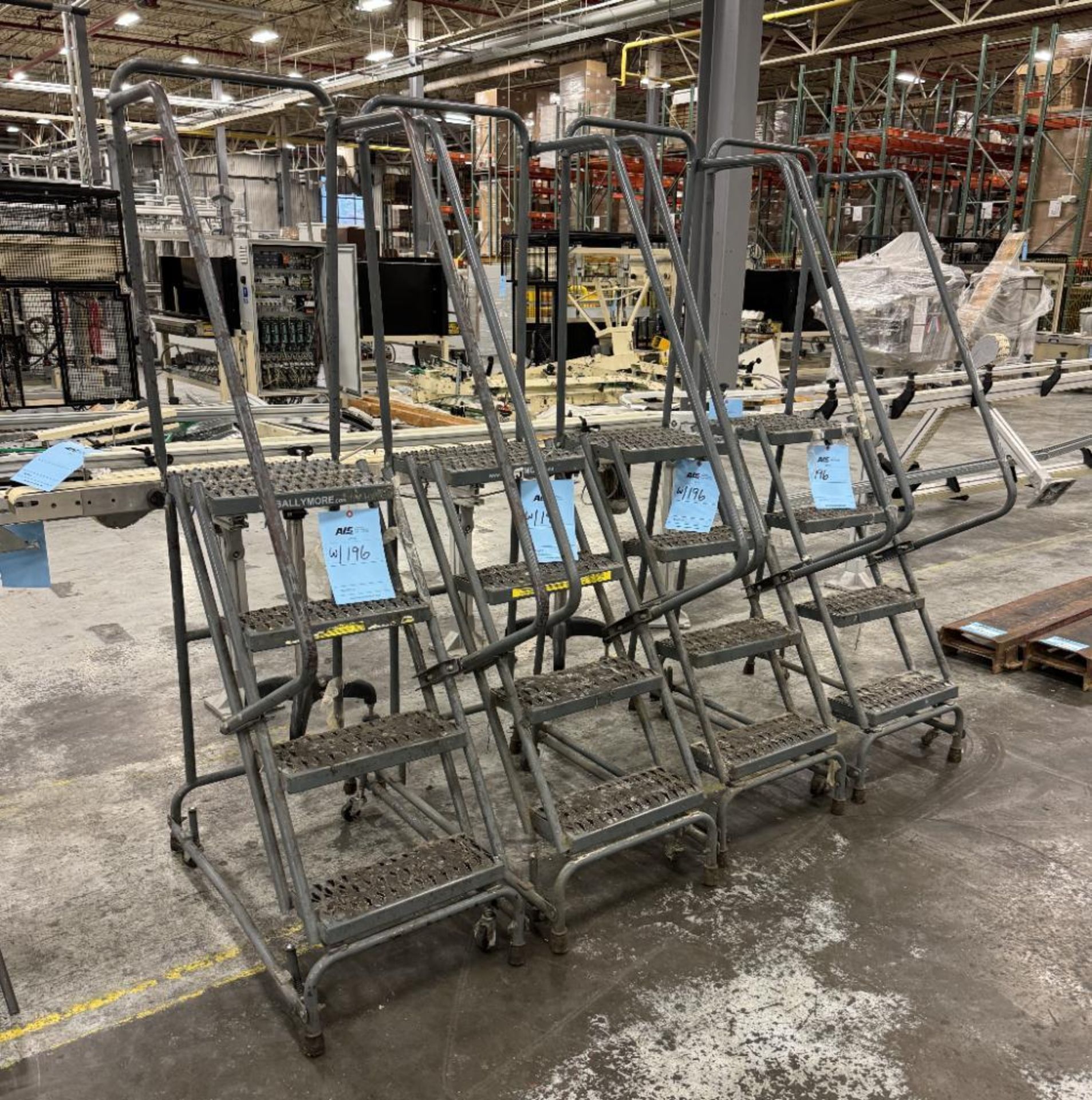 Lot Of (4) Approximate 4' Rolling Step Ladders.