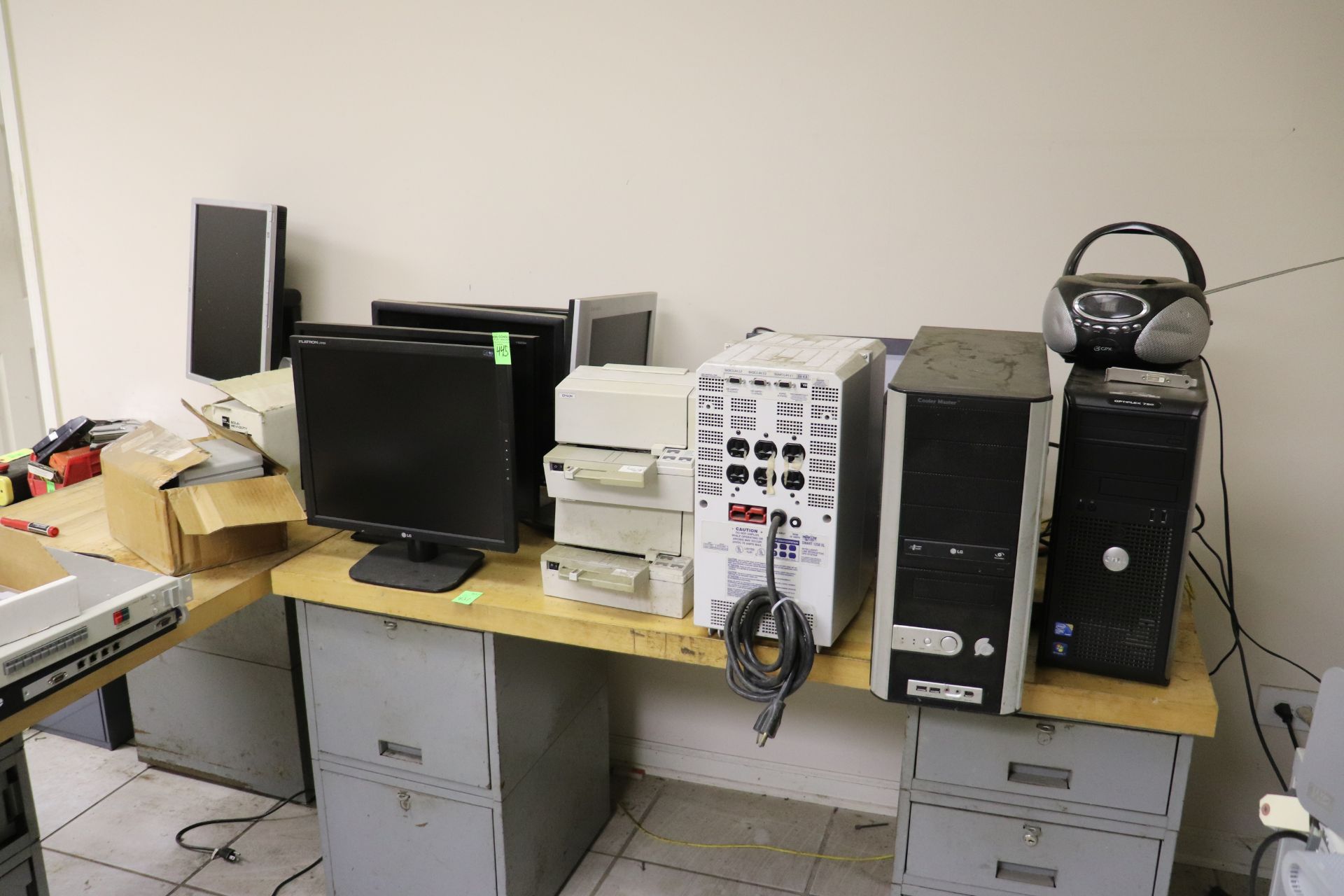 Six computer monitors, two Epson printers, Wacom drawing pad, Tripp Lite Smart 1250XL, and two deskt