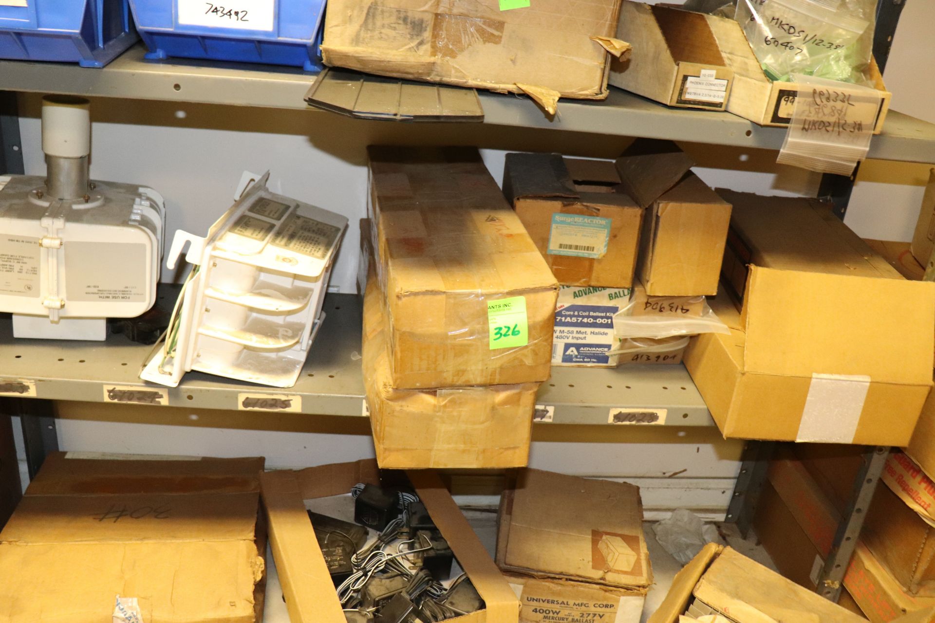 Shelf of electrical components including Holophane ballasts, mercoid controls, corm ballasts, everyt