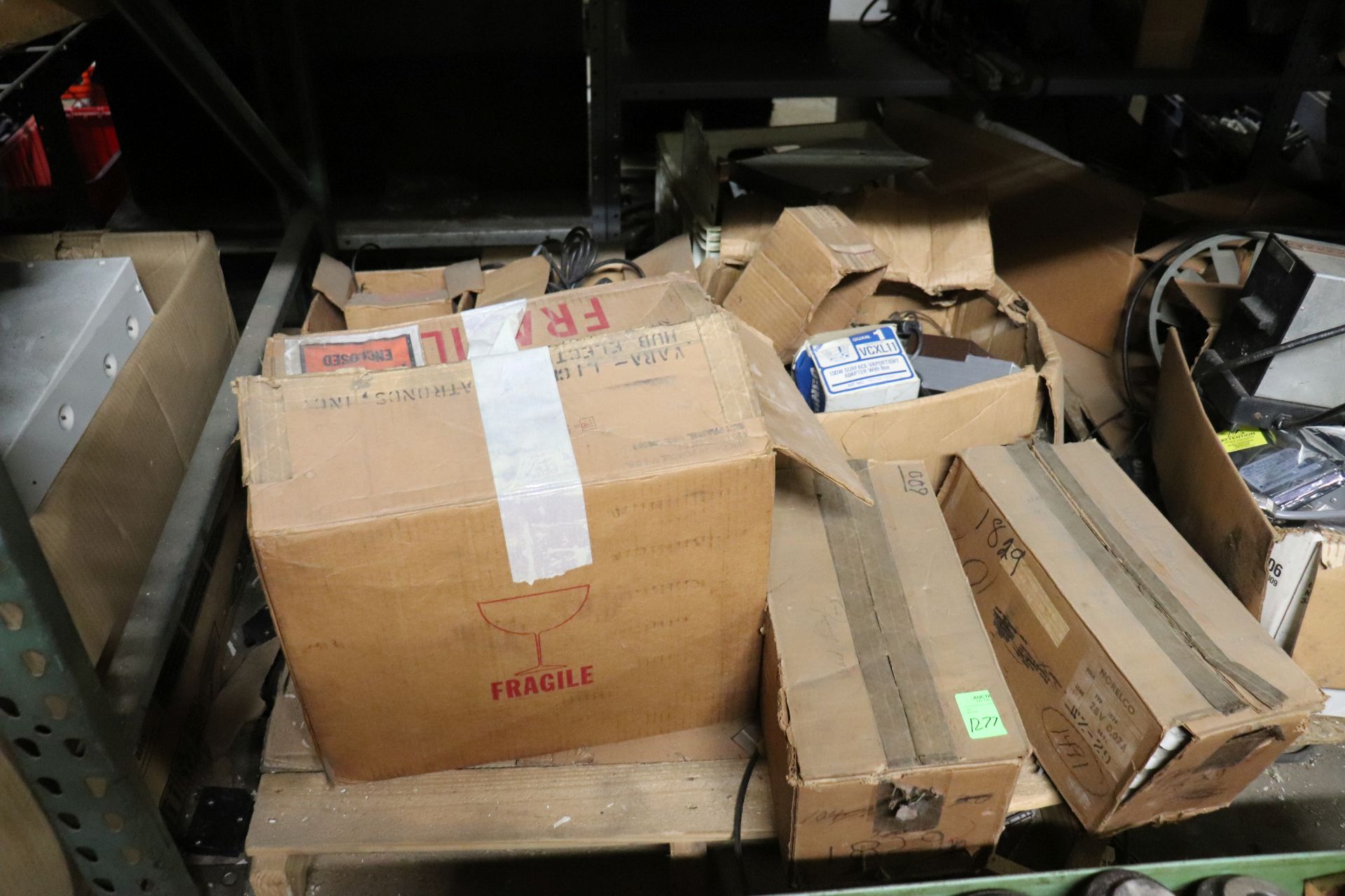 Pallet of small light bulbs, electrical components, circuit breakers, power bricks, and electric mot