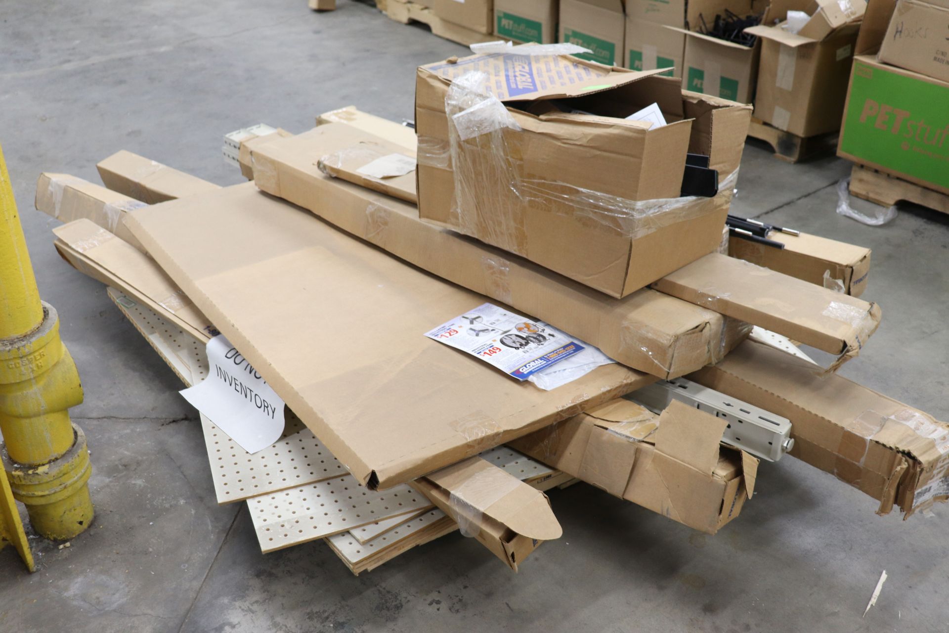 One pallet of display sign stands, pegboard, wall mounted shelf, and support brackets