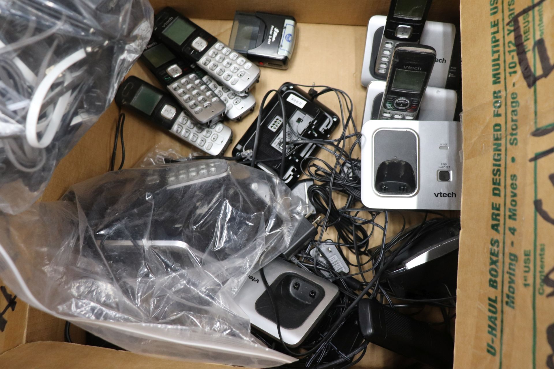 Box of telephone equipment including numerous Vtech cordless landline telephones and three Avaya han - Image 2 of 4