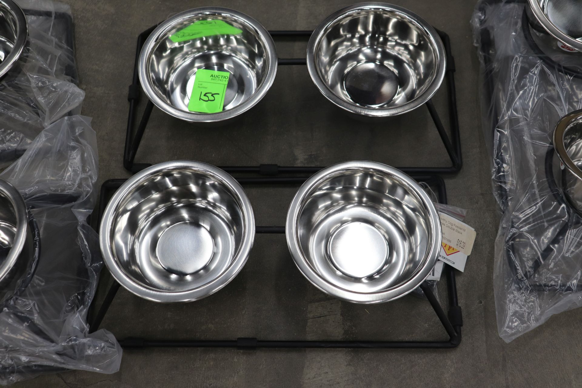 Two small Worthy Dog Company food and water bowl stands with stainless steel bowls