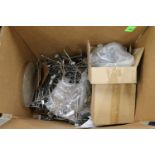 Box with miscellaneous slat wall display hooks and tablecloths