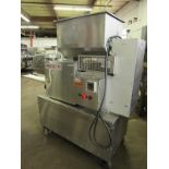 Nutec Mdl. 710 Portable Patty Forming Machine with paper feed setup with 4 1/2" diameter X 3/8"