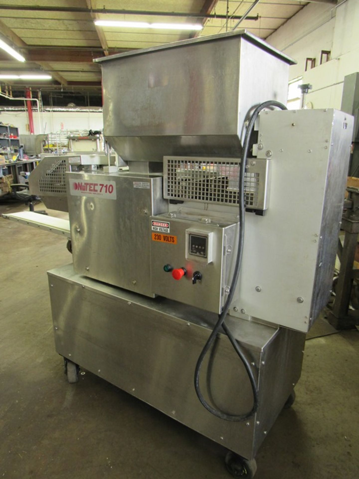 Nutec Mdl. 710 Portable Patty Forming Machine with paper feed setup with 4 1/2" diameter X 3/8"