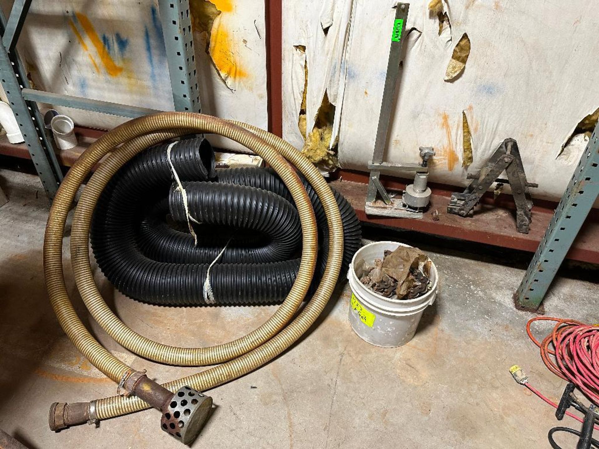 PUMP HOSE WITH ASSORTED TUBING AND MISC. ITEMS IN CORNER