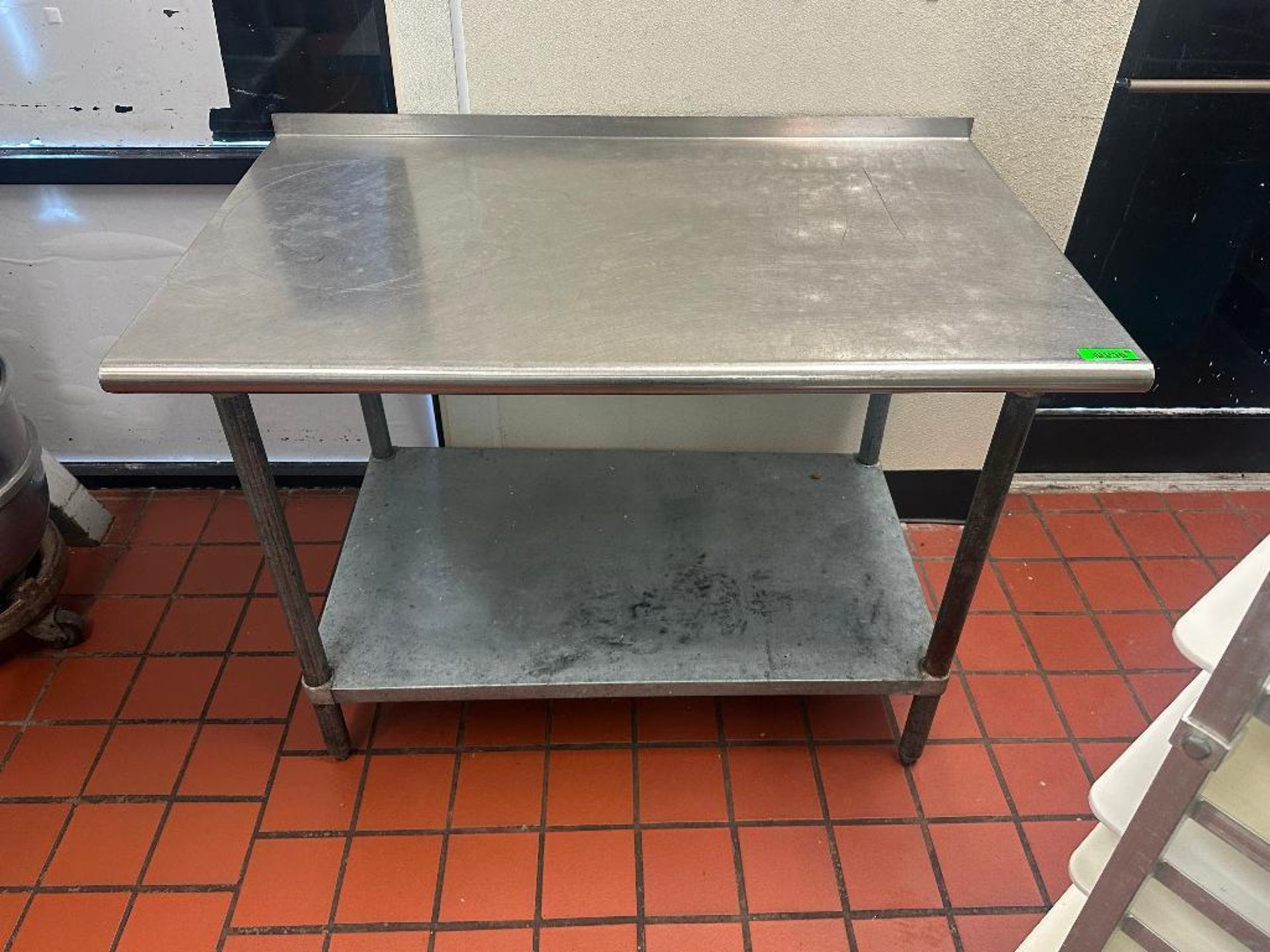 DESCRIPTION 48 "X 30" STAINLESS TABLE W/ 1" BACK SPLASH SIZE 48 "X 30" LOCATION 7399 O'Connor Drive,