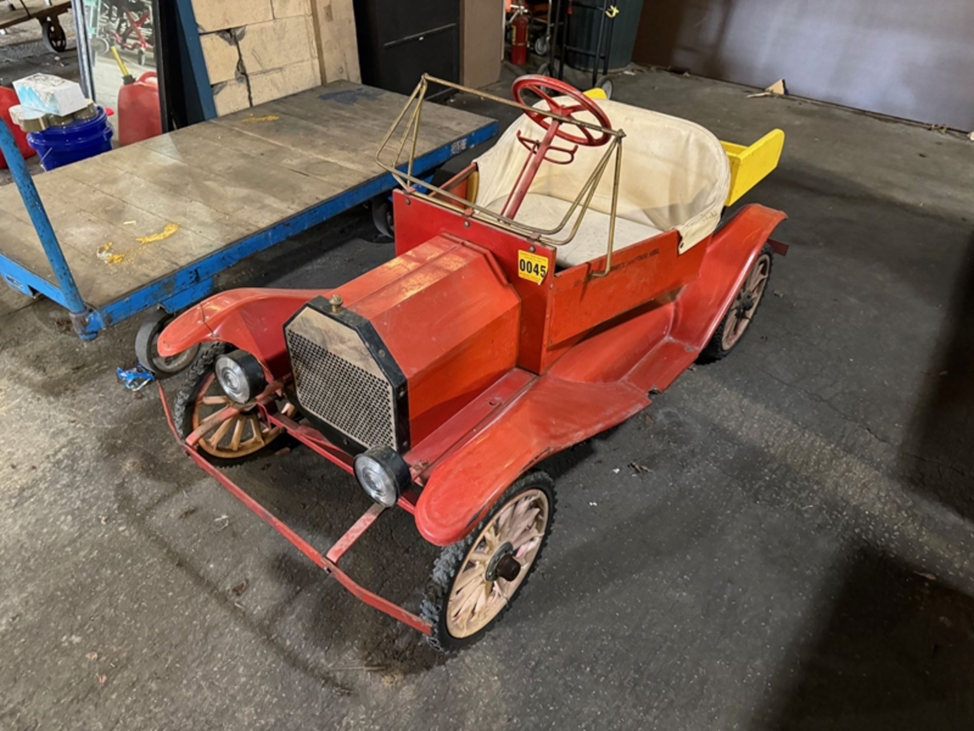 Antique gas-powered miniature parade truck with dump body