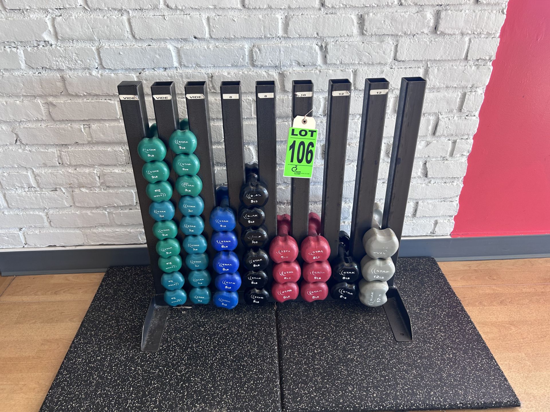 Lot of assorted weights with weight stand includes: (18) 3lbs, (5) 5lbs, (6) 6lbs, (8) 8lbs, (3)